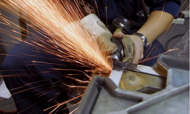 Man grinding metal