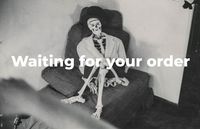 A skeleton sitting on a sofa