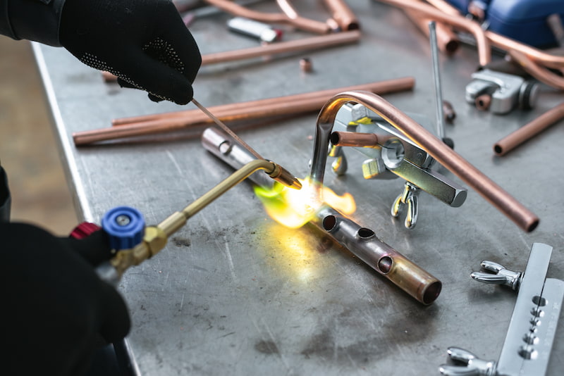 pipework on a factory workbench, blow lamp soldering